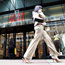 A woman walks past an H&M store