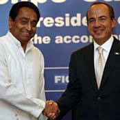 Mexican President Felipe Calderon shakes hands wit 