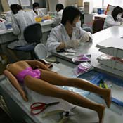 Workers check toys at a toy testing lab in China 