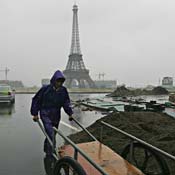 Chinese construction worker works in rain 