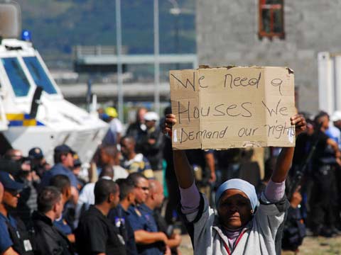 
                Hundreds of residents of the Joe Slovo informal settlement demonstrate against the lack of services provided by the government in the Gugulethu township on the outskirts of Cape Town.
                                    (AFP/Getty Images)
                                