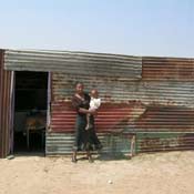 Elsie Gambu, 22, lives with her son in this house made of tin siding.