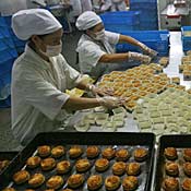 Workers pack moon cakes at Nanjing  food factory 