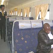 Inside the Soweto Business Express, plush blue seats line the aisles.