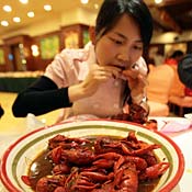 Chinese woman eats spicy crayfish 