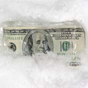 Hundred dollar bills chilling in snow 
