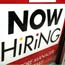 A "Now Hiring" sign