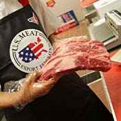 Grocery store clerk handles U.S. meat 