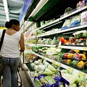 Shopper browses vegetable display 