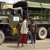 A Somali man on crutches passes patrol 