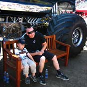 Escalade's Mohawk-haired driver, George Balhan, poses for a pre-competition picture with a Swedish fan at Ullevi stadium in Gothenberg, Sweden. The car's tires are 66-inches in diameter and boast the world's largest wheel "spinners."