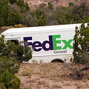 A FedEx truck makes a delivery. 