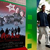 Pedestrians pass a closed movie theater in Beijing 