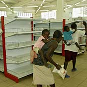 Shoppers in an almost empty supermaket. 