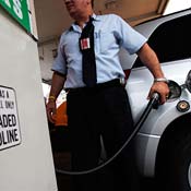 A man pumps gas into an SUV 