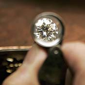 A jeweler examines a diamond 