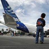 A young boy looks over an Airbus A380 