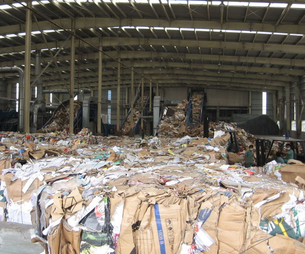 
                Waste paper enters the plant.
                                    (Scott Tong)
                                