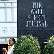 Woman sits outside Wall Street Journal office 