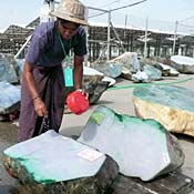A worker prepares jade for auction in Myanmar. 
