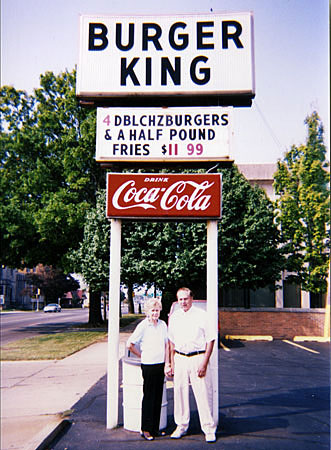 
                Gene and Betty Hoots under their Burger King restaurant sign.
                                    (Jeremy Hobson)
                                