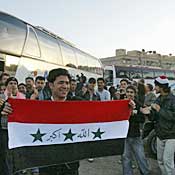 Iraqi refugee holds Iraq flag 