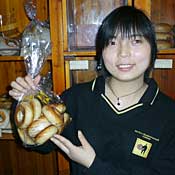 Clerk with bag of bagels in Shanghai 