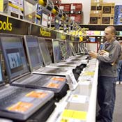 A shopper browses laptops 