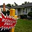 Reduced price sign in front of house