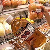 Customer holds a bottle of apple juice in Beijing 