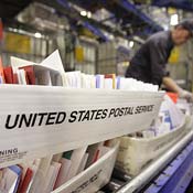 A mail carrier sorts letters at the Post Office 