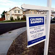 For Sale sign in front of foreclosed home 