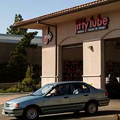 A car leaving a Jiffy Lube lot 