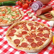 Tantalizing pizzas on a red-checkered tablecloth 