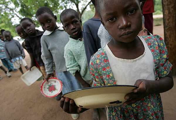 
                Zimbabwean children wait for food.
                                    (Alexander Joe/AFP/Getty Images))
                                