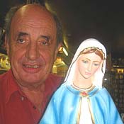 Shopkeep Tom Byrne with one of his wares: a statue of the Virgin Mary --- or, as she's called in Knock, "Our Lady of Knock."