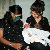 Karen Kim holds son, Brady. 