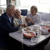 Bill Clinton  hugs woman at Iowa diner 