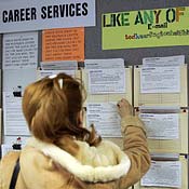 A woman takes a file at a job board in Illinois. 