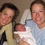 Katie, with a client and her newborn. Katie recently worked her 100th birth as a Doula.