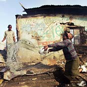 Woman puts out violence-caused fire in Kenya 