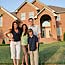 Family in front of suburban home