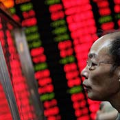 A Chinese investor looks at a stock price board. 