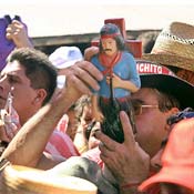 A follower of Gauchito Gil holds up an effigy 