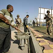 Workers repair pavement in central Baghdad 