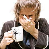 A sick woman sneezes 