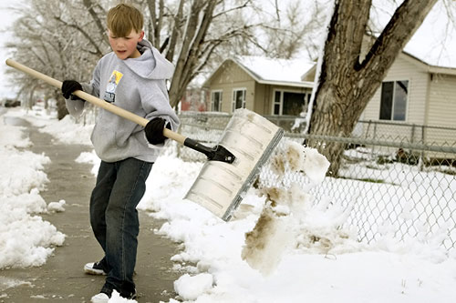 
                    A Montana boy shovels snow after a spring storm.
                                            (Stephen Brashear / Getty Images)
                                        