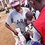 A Kenyan mother gets items in Red Cross line