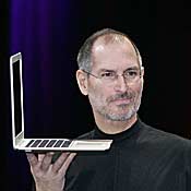 Steve Jobs holds up the new Mac Book Air 