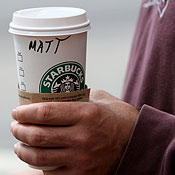 Starbucks customer Matt holds a coffee drink. 